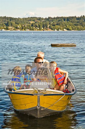 men and young children on motorboat ride