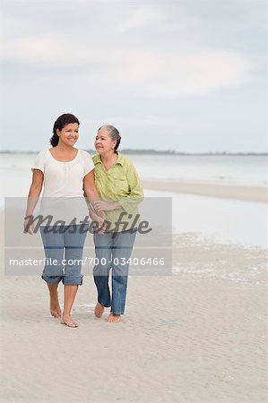 Mother and Daughter Walking on Beach