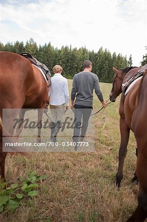 Couple Leading Horses, Brush Prairie, Washington, USA