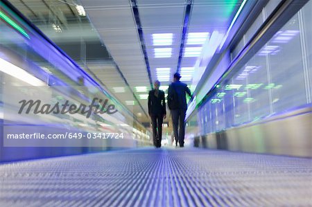 conveyor belt with couple in background