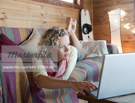 woman in a beach house,using computer