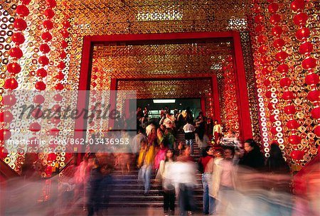 Visitors stream through the entrance to the Star House shopping centre,decorated for Chinese New Year. The shopping complex sits on Victoria Harbour next to the Ocean