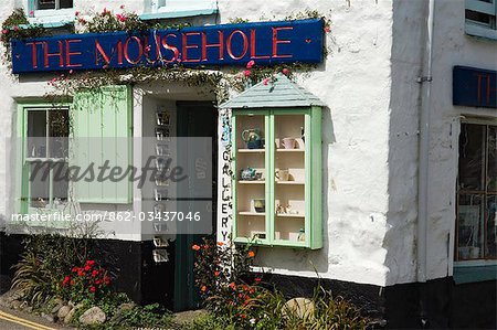 A crafts shop sells curios to tourists at the old fishing village of Mousehole,Cornwall,England