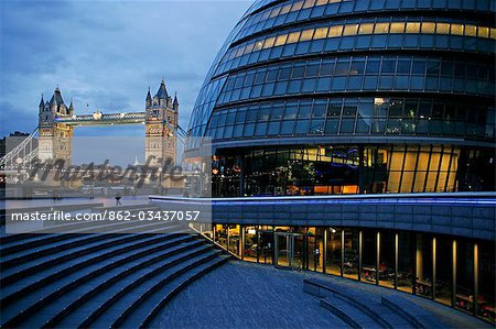 England,London. City Hall designed by architect Norman Foster with Tower Bridge in the background.