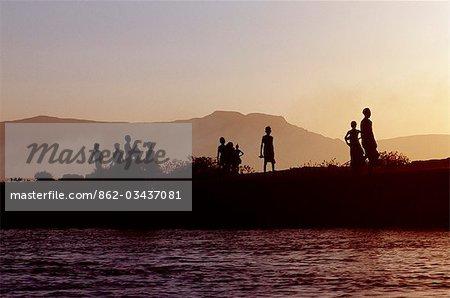 Dassanech children play on the bank of the Omo River at sunset. Much the largest of the tribes in the Omo Valley numbering around 50,000,the Dassanech (also known as the Galeb,Changila or Merille) are Nilotic pastoralists and agriculturalists.