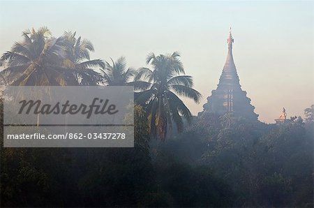 Myanmar,Burma,Mrauk U. Early morning mist shrouds an historic temple of Mrauk U which was built in the Rakhine style between the 15th and 17th centuries.