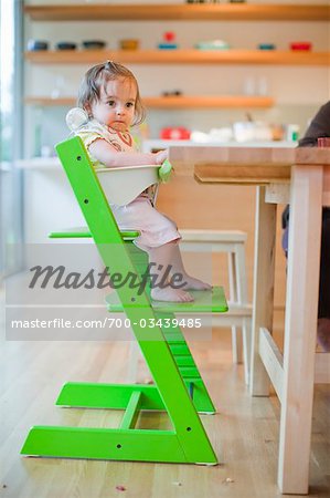 Baby Girl in Her High Chair on Her First Birthday
