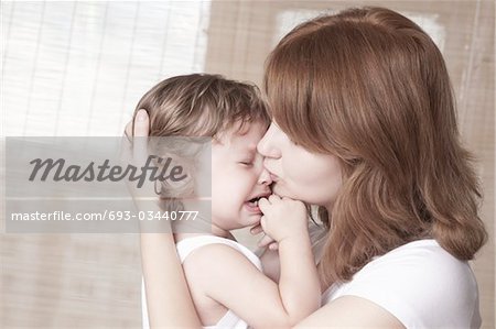 Mother comforts crying child