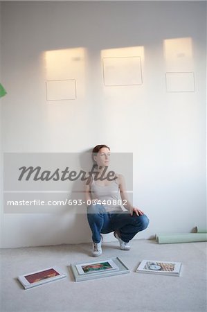 Woman decides on pictures to mount in new apartment
