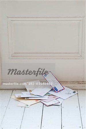 Letters on floorboards at front door