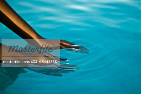 Hands in blue water