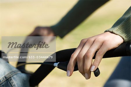 Woman riding bicycle, cropped view