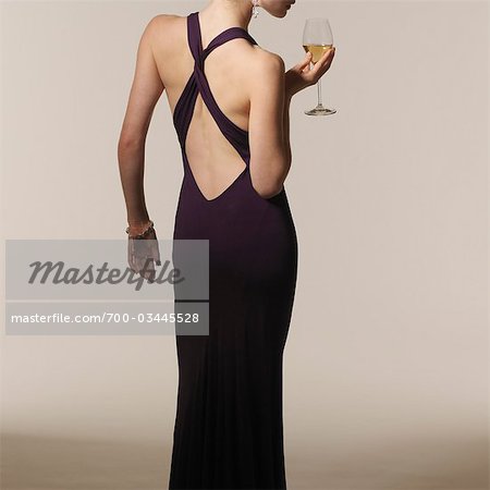 Back View of Woman wearing Evening Gown and holding Glass of Wine