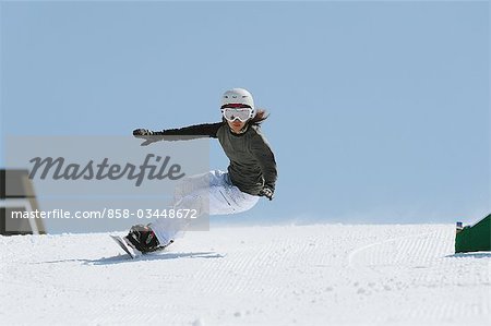 Woman Snowboarding with Arms Outstretched