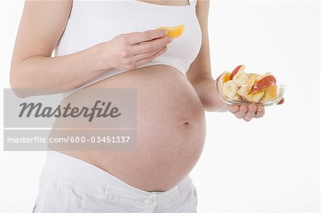 Pregnant Woman Eating Fruit