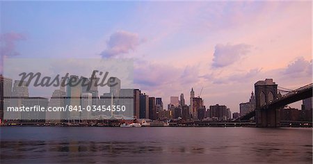 Brooklyn Bridge spanning the East River and the Lower Manhattan skyline at dawn, New York City, New York, United States of America, North America Brooklyn Bridge spanning the East River and the Lower Manhattan skyline at dawn, New York City, New York, United States of America, North America