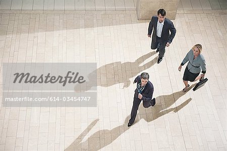 Businesspeople running in lobby