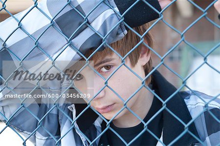 Boy Behind Fence