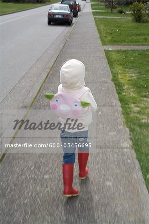 Little Girl Running on the Sidewalk