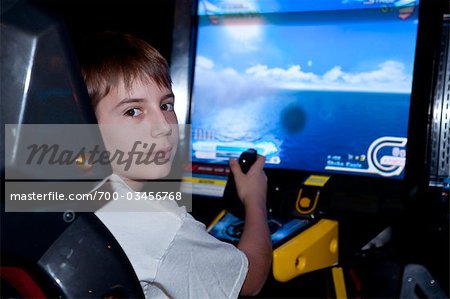 Boy Playing Arcade Game