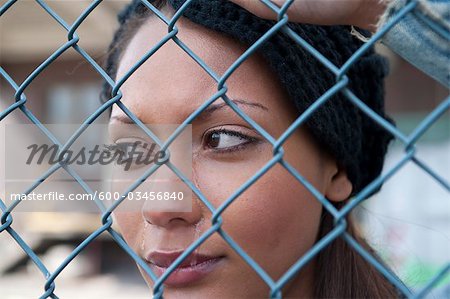 Woman Crying behind Fence