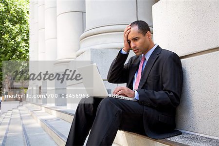 Homme d'affaires avec ordinateur portable à l'extérieur