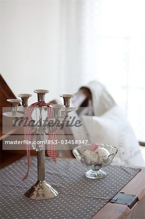 Candleholder and small bowl on a table