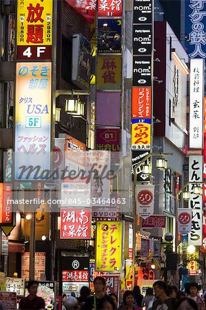 Une petite rue dans le quartier animé de Shinjuku, plein de signes colorés et de petites annonces, Tokyo, Japon.
