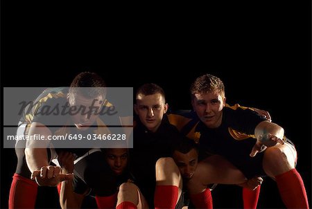 Rugby players in scrum formation