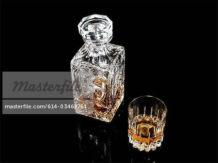 Whiskey in glass and decanter Whiskey in glass and decanter