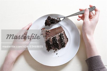 Young woman eating chocolate cake