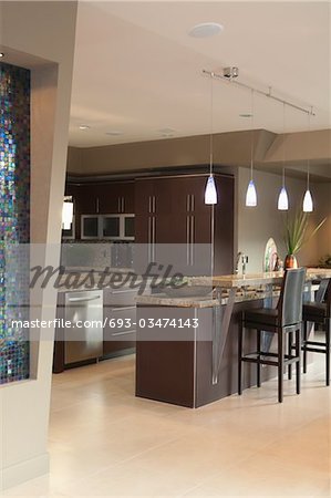 Dark brown kitchen with bar stools