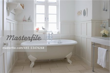 Freestanding roll top in panelled bathroom, London