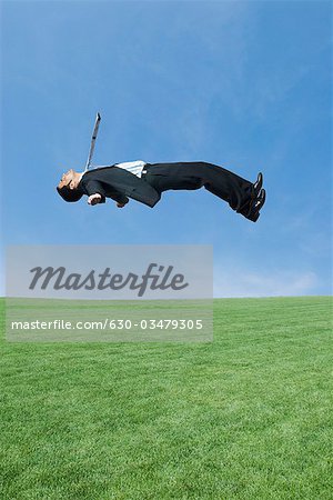 Side profile of a businessman in mid-air