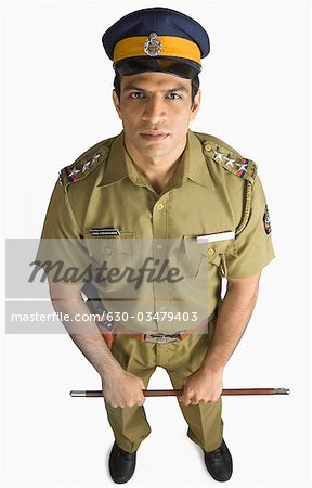 Portrait of a policeman holding a nightstick