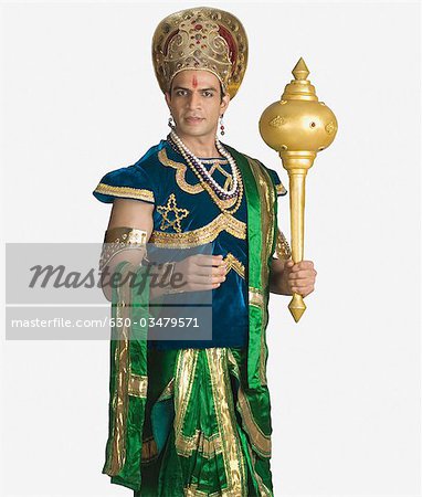 Young man dressed-up as Bhima and holding a mace