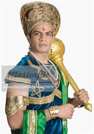 Young man dressed-up as Bhima and holding a mace