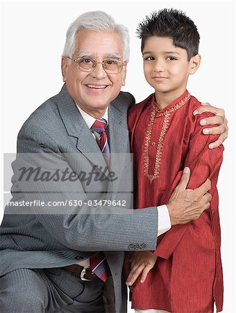 Portrait of a senior man hugging his grandson