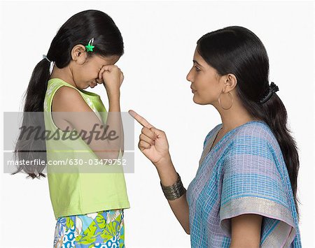 Side profile of a young woman scolding her daughter