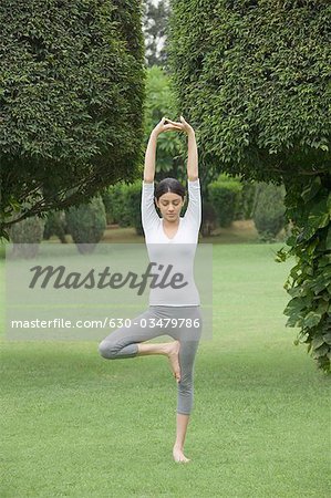 Woman practicing yoga in a park