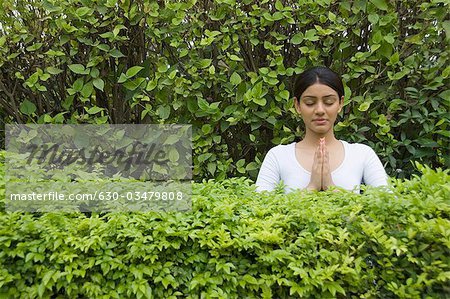 Woman practicing yoga in a park