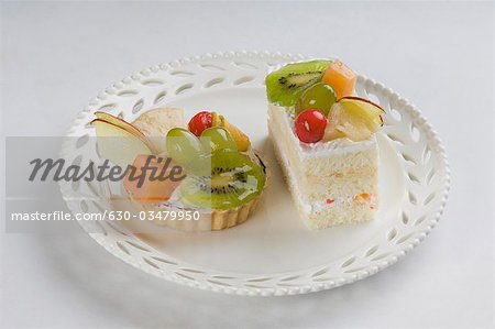 Close-up of fruit tart with a pastry in a plate