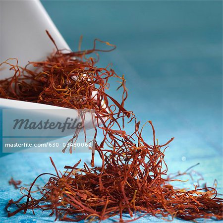 Saffron threads spilling from a bowl