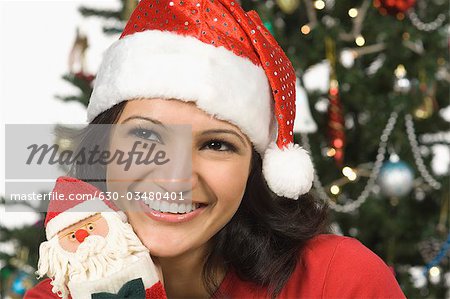 Close-up of a woman holding a Christmas stocking and day dreaming