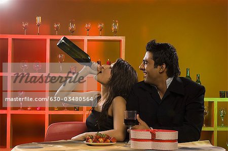 Close-up of a couple drinking wine in a bar