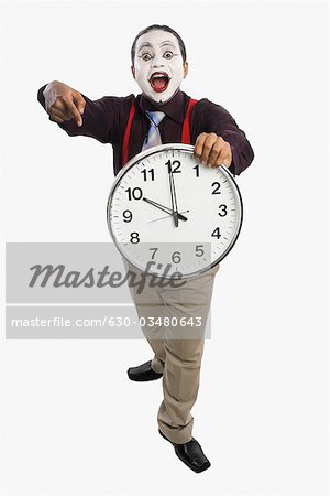 Mime showing a clock