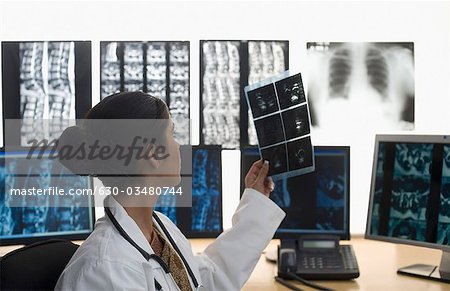 Female doctor examining an X-Ray report