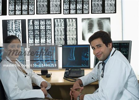 Portrait of a female doctor smiling with a male doctor