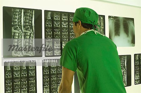 Male surgeon examining an X-Ray report