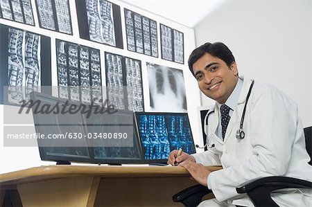 Male doctor writing a prescription